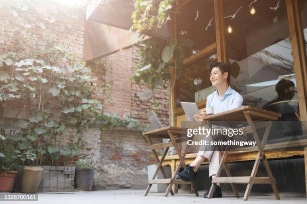 business men working in outdoor cafes - sunlit cafe male stock pictures, royalty-free photos & images