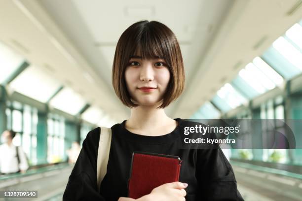 young asian woman holding a digital tablet - beautiful asian student stock pictures, royalty-free photos & images