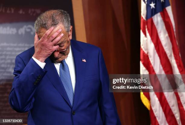 Senate Majority Leader Charles Schumer scratches his head as he attends a press conference on introducing legislation to end federal cannabis...