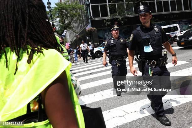 Officers arrive as people block traffic during a protest to demand German Chancellor Angela Merkel and Pfizer make the coronavirus vaccine and...