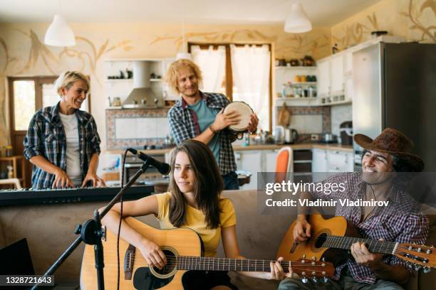 musicians different ages having fun while playing music at home - rock band shirt stock pictures, royalty-free photos & images