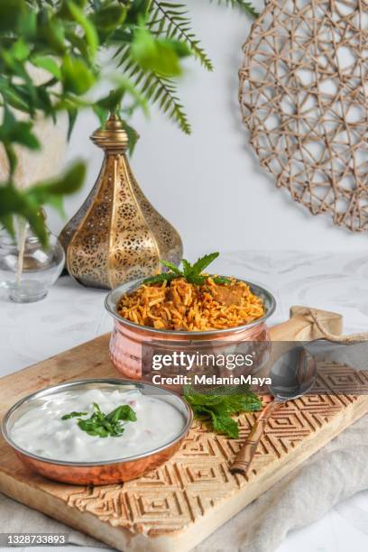 traditional lamb biriyani mutton with yogurt dip raita - biriyani stockfoto's en -beelden