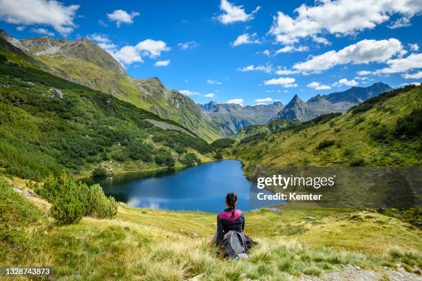 resting at beautiful small lake in the mountains - vorarlberg imagens e fotografias de stock