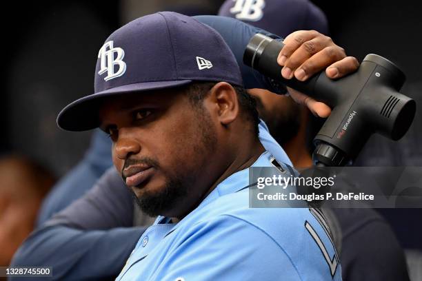 Third base coach Rodney Linares of the Tampa Bay Rays uses a Hyperice massager prior to the game against the Toronto Blue Jays at Tropicana Field on...