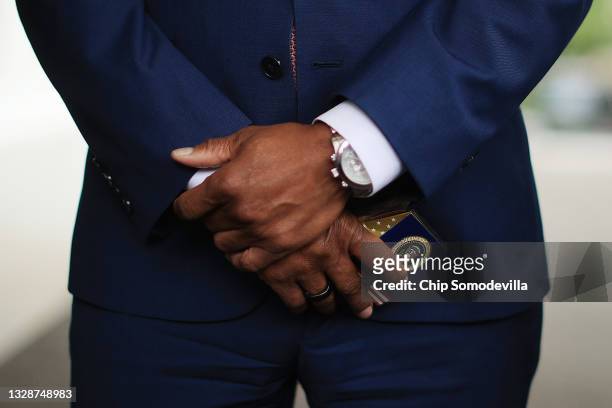 Denver Mayor Michael Hancock holds a box of presidential M&Ms while talking to reporters outside the West Wing following a meeting with U.S....