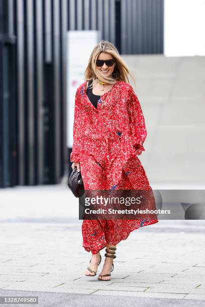 Influencer Gitta Banko wearing a red longsleeve summer silk maxi dress with tied waist and abstract pattern by an an londree, a black tank top by...