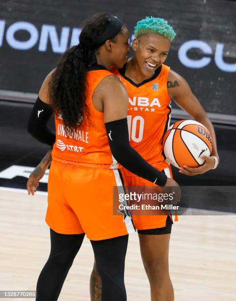 Arike Ogunbowale and Courtney Williams of Team WNBA hug on the court as time expires in the 2021 WNBA All-Star Game at Michelob ULTRA Arena on July...