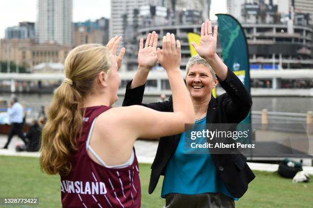 Australian Olympic gold medallist Natalie Cook high fives young fans during the Australian Olympic Committee announcement of the Olympics Live...