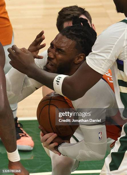 Jae Crowder of the Phoenix Suns tangles with Pat Connaughton of the Milwaukee Bucks during the second half in Game Four of the NBA Finals at Fiserv...