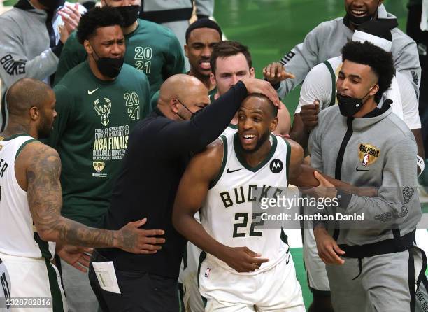 Khris Middleton of the Milwaukee Bucks is congratulated by teammates during the second half in Game Four of the NBA Finals against the Phoenix Suns...