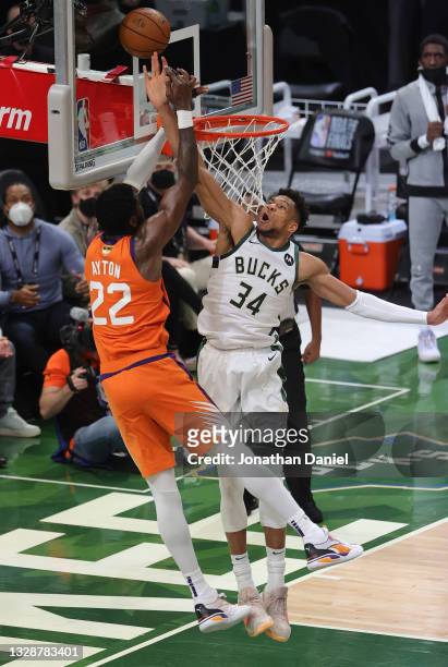 Giannis Antetokounmpo of the Milwaukee Bucks blocks a shot by Deandre Ayton of the Phoenix Suns during the second half in Game Four of the NBA Finals...