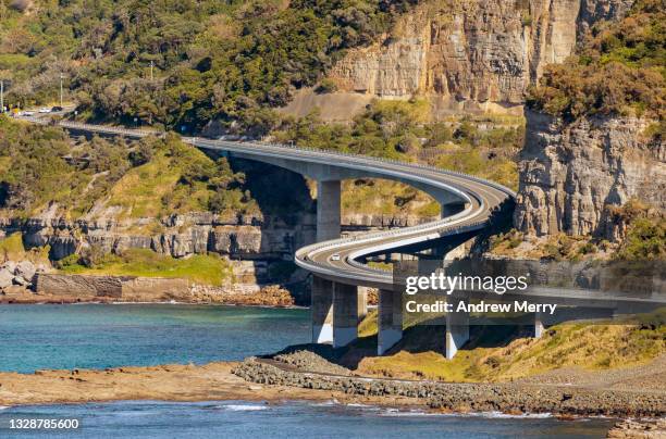 sea cliff bridge, rocky coastline, highway and mountain - road trip new south wales stock pictures, royalty-free photos & images