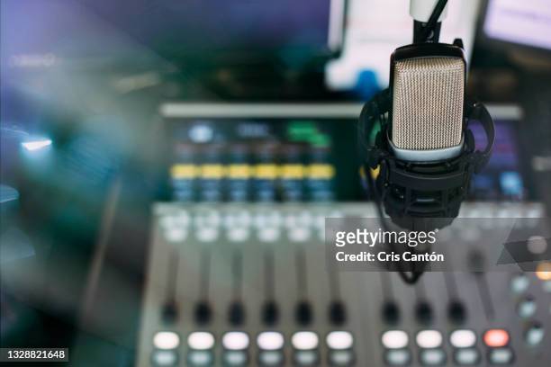 radio broadcast studio with microphone and sound mixer console on the background - radio stock pictures, royalty-free photos & images