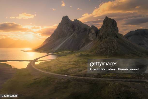 scenic road in iceland, beautiful nature landscape aerial panorama, mountains and coast at sunset - islândia - fotografias e filmes do acervo