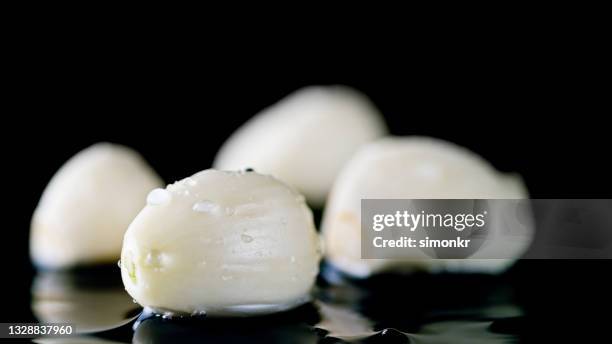 water droplets on garlic clove - garlic clove stock pictures, royalty-free photos & images