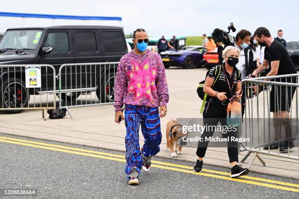 Lewis Hamilton of Great Britain and Mercedes GP walks in the Paddock during previews ahead of the F1 Grand Prix of Great Britain at Silverstone on...