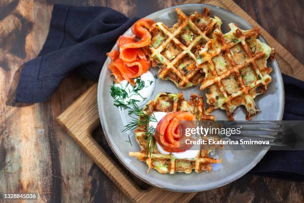 savory zucchini cheese waffles served with salted salmon and sour cream - gaufre photos et images de collection