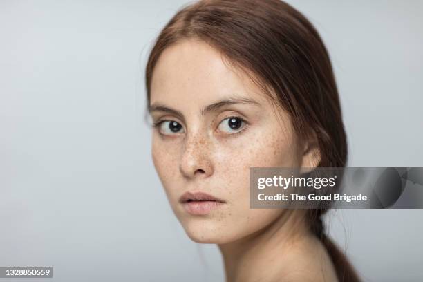 close-up portrait of confident young woman - freckle faced stock pictures, royalty-free photos & images