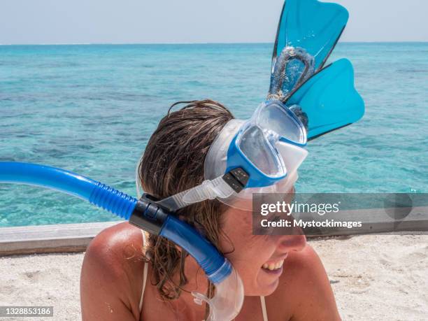 portrait of happy young woman enjoys snorkelling in tropical lagoon - diving flippers stock pictures, royalty-free photos & images