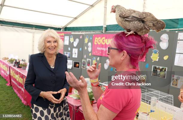 Camilla, Duchess of Cornwall meets Deb Howe, who has a chicken on her head, during the Duchess of Cornwall's visit to The Great Yorkshire Show on...