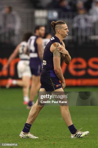 Nat Fyfe of the Dockers holds his injured shoulder during the round 18 AFL match between the Fremantle Dockers and Geelong Cats at Optus Stadium on...