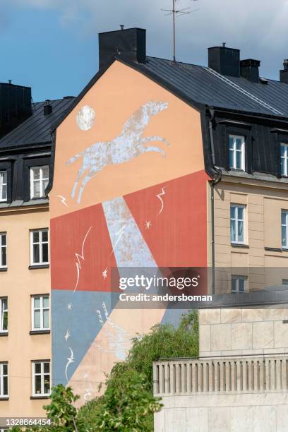 painted artwork mural on house facade in stockholm - facade painting stock pictures, royalty-free photos & images