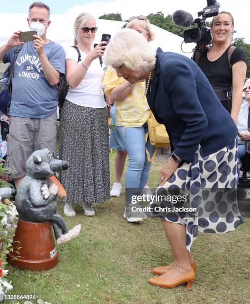 Camilla, Duchess of Cornwall looks at a garden gnome named Charles during her visit to The Great Yorkshire Show on July 15, 2021 in Harrogate,...