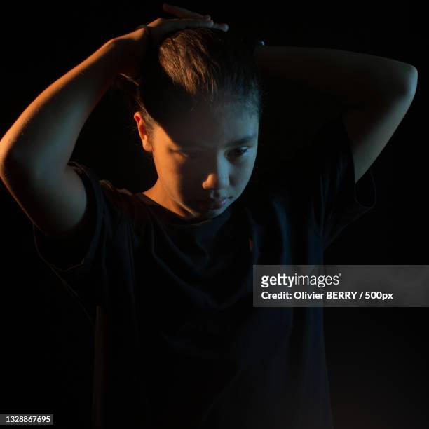 young man standing against black background,vietnam - couleur noire 個照片及圖片檔
