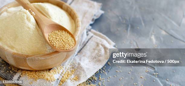 bowl of raw amaranth flour with a spoon of amaranth seeds - amarant stock pictures, royalty-free photos & images