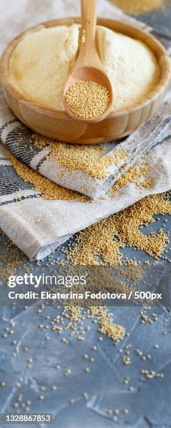 bowl of raw amaranth flour with a spoon of amaranth seeds - amarant stock pictures, royalty-free photos & images