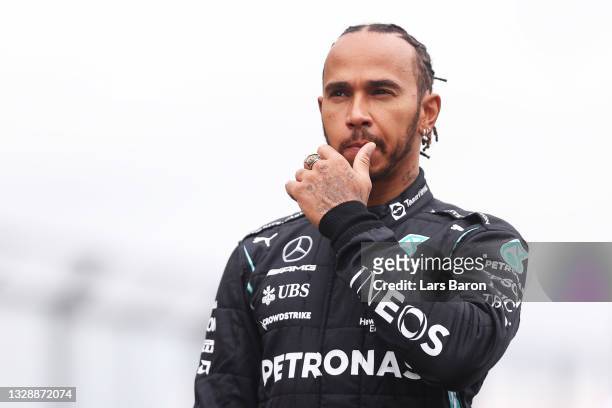 Lewis Hamilton of Great Britain and Mercedes GP looks on as the prototype for the 2022 F1 season is unveiled during previews ahead of the F1 Grand...