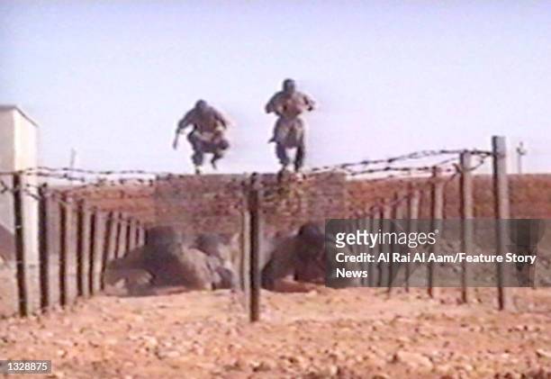 Fighters participate in military training in this undated still frame from a recruitment video for Osama bin Laden''s extremist Al-Qaida network.