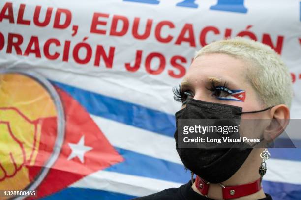 Demonstrator with make-up of Cuba's national flag as Cuban residents residing in Colombia that protest against the president Miguel Diaz-Cannel...