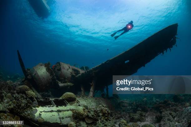 ii ww sunken airplane wreck and diver - palau, micronesia - air crash investigation stock pictures, royalty-free photos & images