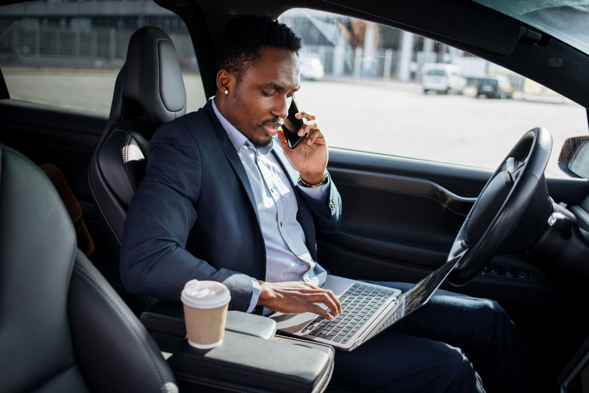 businessperson working in car