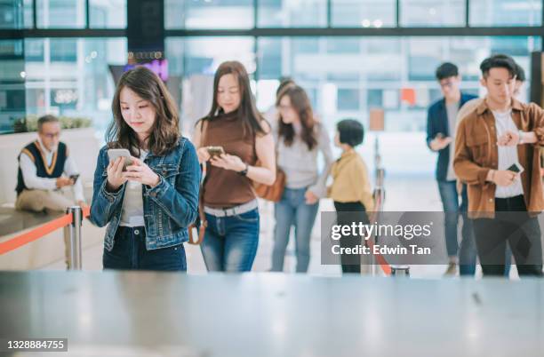 group of asian chinese audience in front ticket counter waiting in line buying movie tickets before movie show time at movie theater cinema - 50 watching video stock pictures, royalty-free photos & images