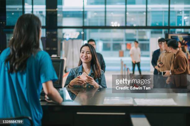 asian chinese female audience  in front ticket counter buying movie tickets , popcorns before movie show time at movie theater cinema - movie counter stock pictures, royalty-free photos & images
