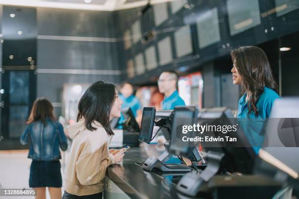 asian chinese audience  in front ticket counter buying movie tickets , popcorns before movie show time at movie theater cinema - movie counter stock pictures, royalty-free photos & images