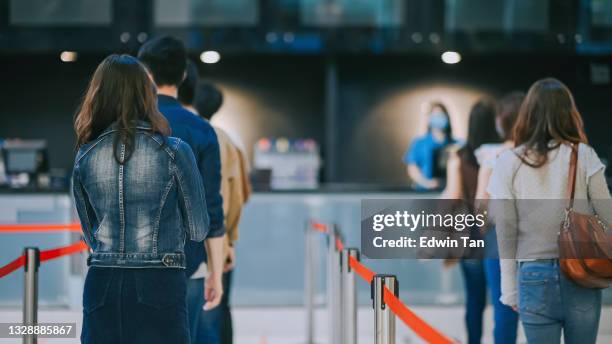 rear view asian chinese crowd people waiting in line buying movie tickets in movie theater cinema - lining up stock pictures, royalty-free photos & images