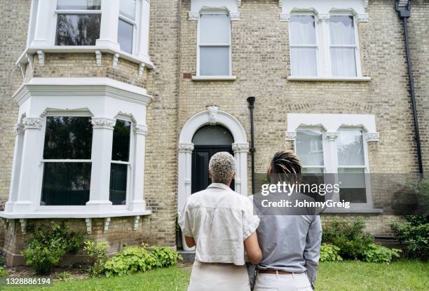 portrait of new homeowners admiring their investment - in front of stock pictures, royalty-free photos & images