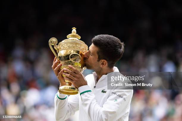 Novak Djokovic of Serbia with the trophy after victory in the Men's Singles Final against Matteo Berrettini of Italy at The Wimbledon Lawn Tennis...