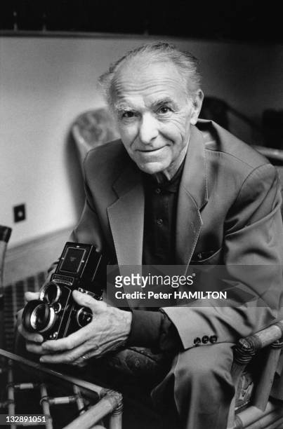 Portrait of photographer Robert Doisneau with a camera Rolleiflex during 1992 in France.