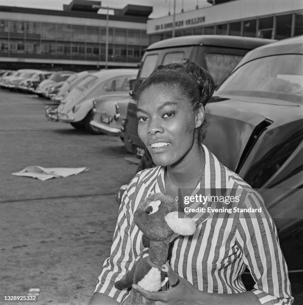 American singer Dionne Warwick arrives at London Airport , UK, 8th July 1965.