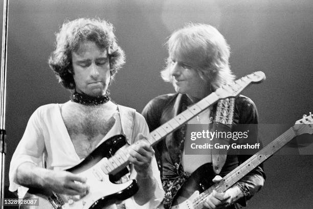 View of, from left, English Rock & Blues musicians Paul Rodgers and Mick Ralphs, both of the band Bad Company, plays guitars as they perform, during...