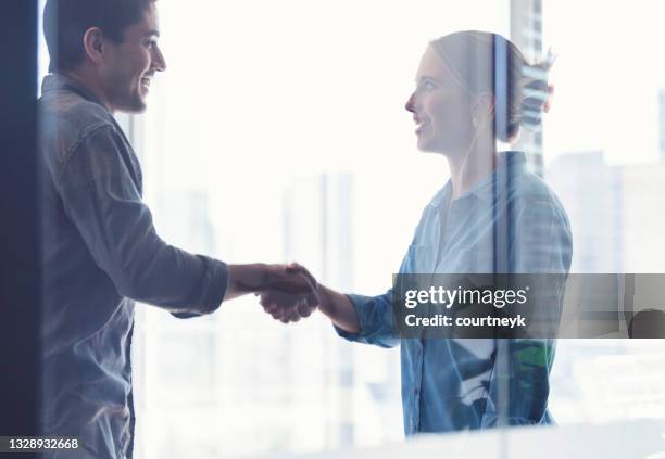 man and woman shaking hands - executive board extraordinary assembly stock pictures, royalty-free photos & images