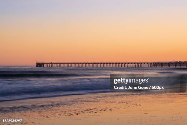 scenic view of sea against clear sky during sunset - golden hour beach stock pictures, royalty-free photos & images