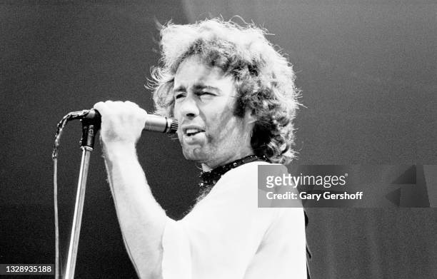 View of English Rock & Blues musician Paul Rodgers, of the band Bad Company, on vocals as he performs, during the 'Burnin' Sky' tour, onstage at...