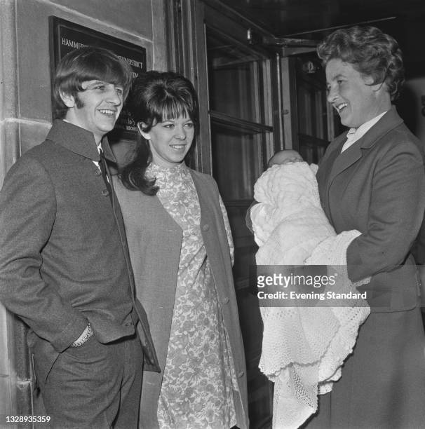 English drummer Ringo Starr of the Beatles with his wife Maureen and their newborn son Zak Starkey, who is in the arms of a nurse at Queen...