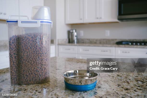 pet food and bowl on kitchen counter - dog bowl stock pictures, royalty-free photos & images
