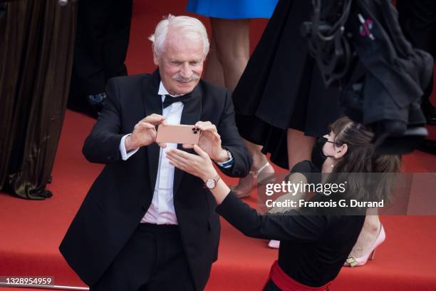 Photographer and director Yann Arthus-Bertrand is reminded not to take photographs as he attends the "France" screening during the 74th annual Cannes...